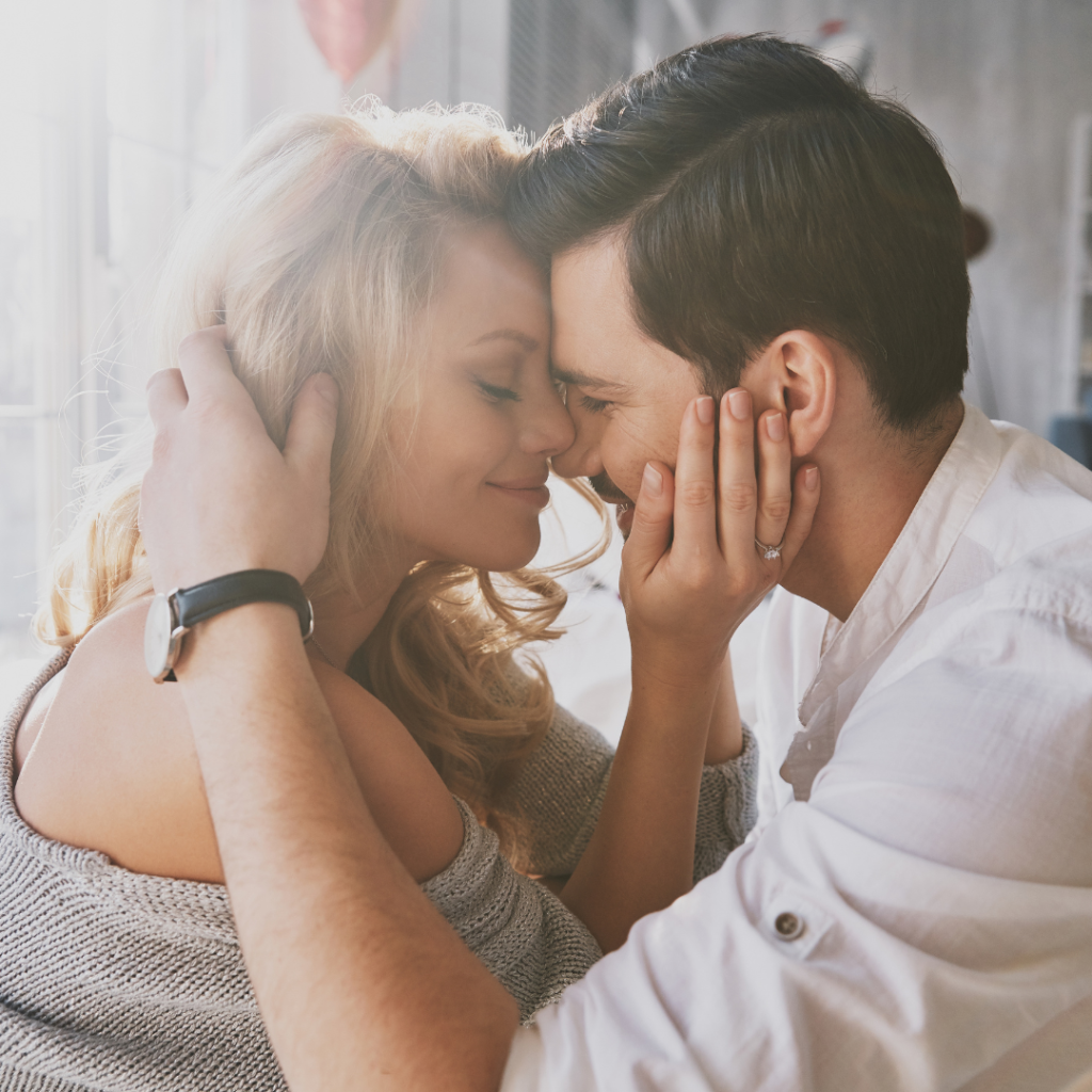 man and woman embracing with foreheads touching