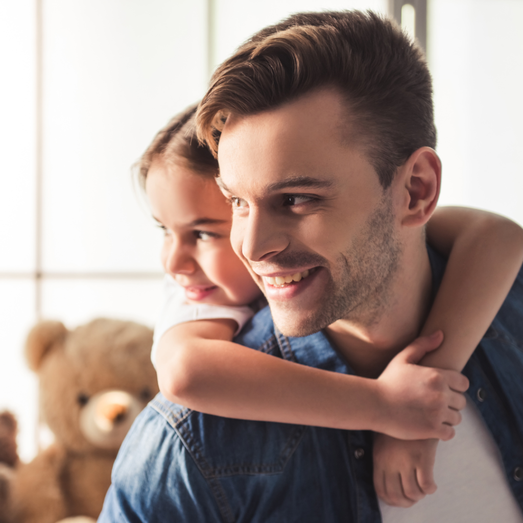 dad giving daughter piggy back ride