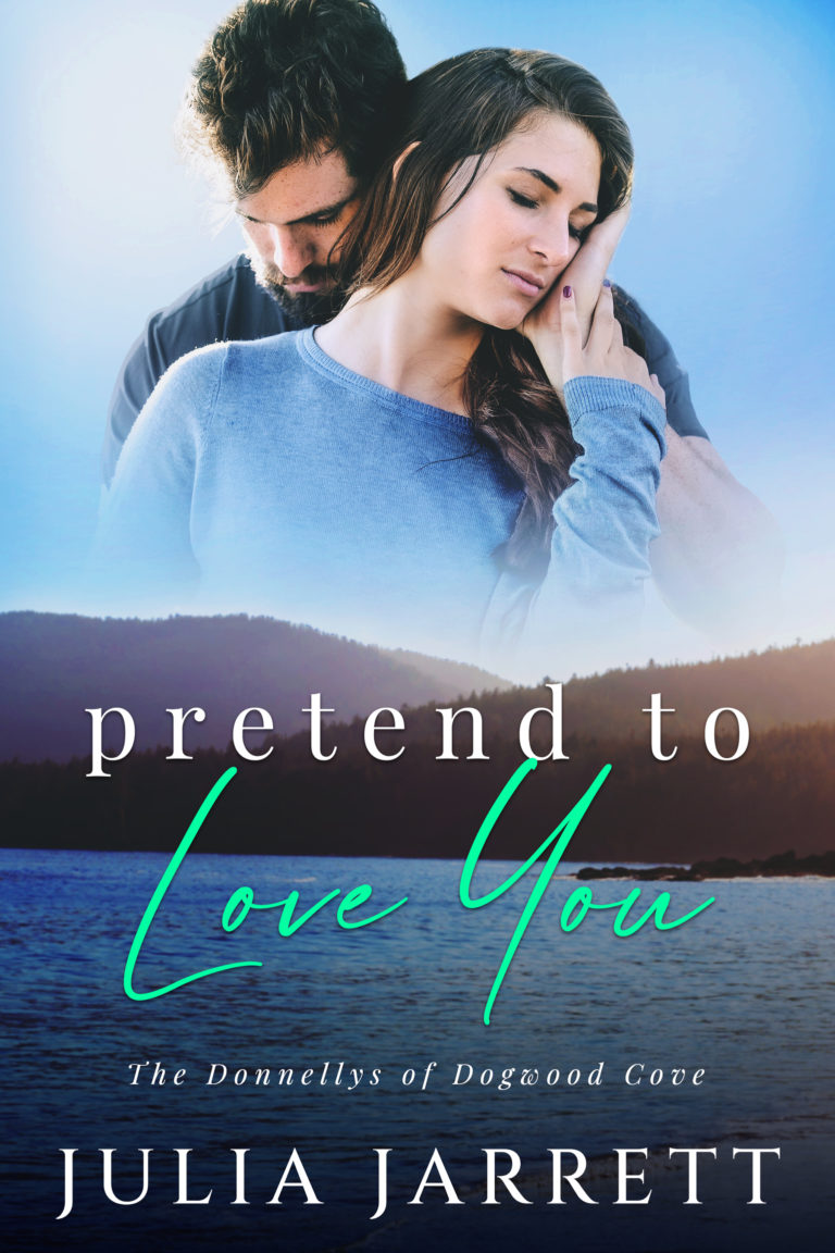 Man standing behind women embracing her with his hand on her cheek. Mountains landscape with lake. Pretend to Love You (Donnellys at Dogwood Cove Book 3) by Julia Jarrett